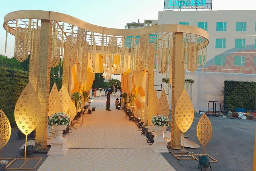 A view of grand entrance decor with golden chandeliers at ExpoInn Suites and Convention.