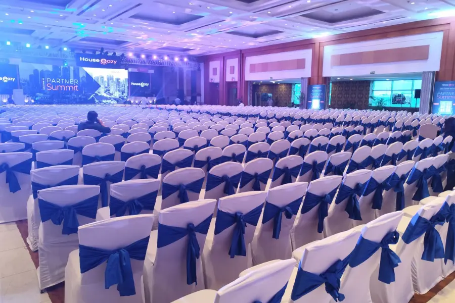 Spacious indoor convention hall set up for a large-scale corporate conference or business summit.